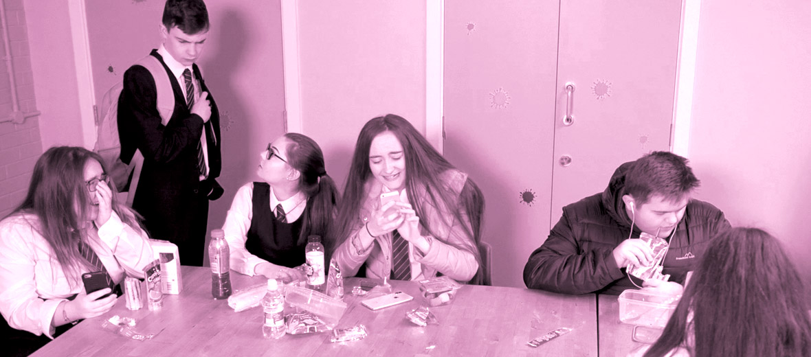 Girls laughing about content shared on phones in the serious about suicide prevention film,